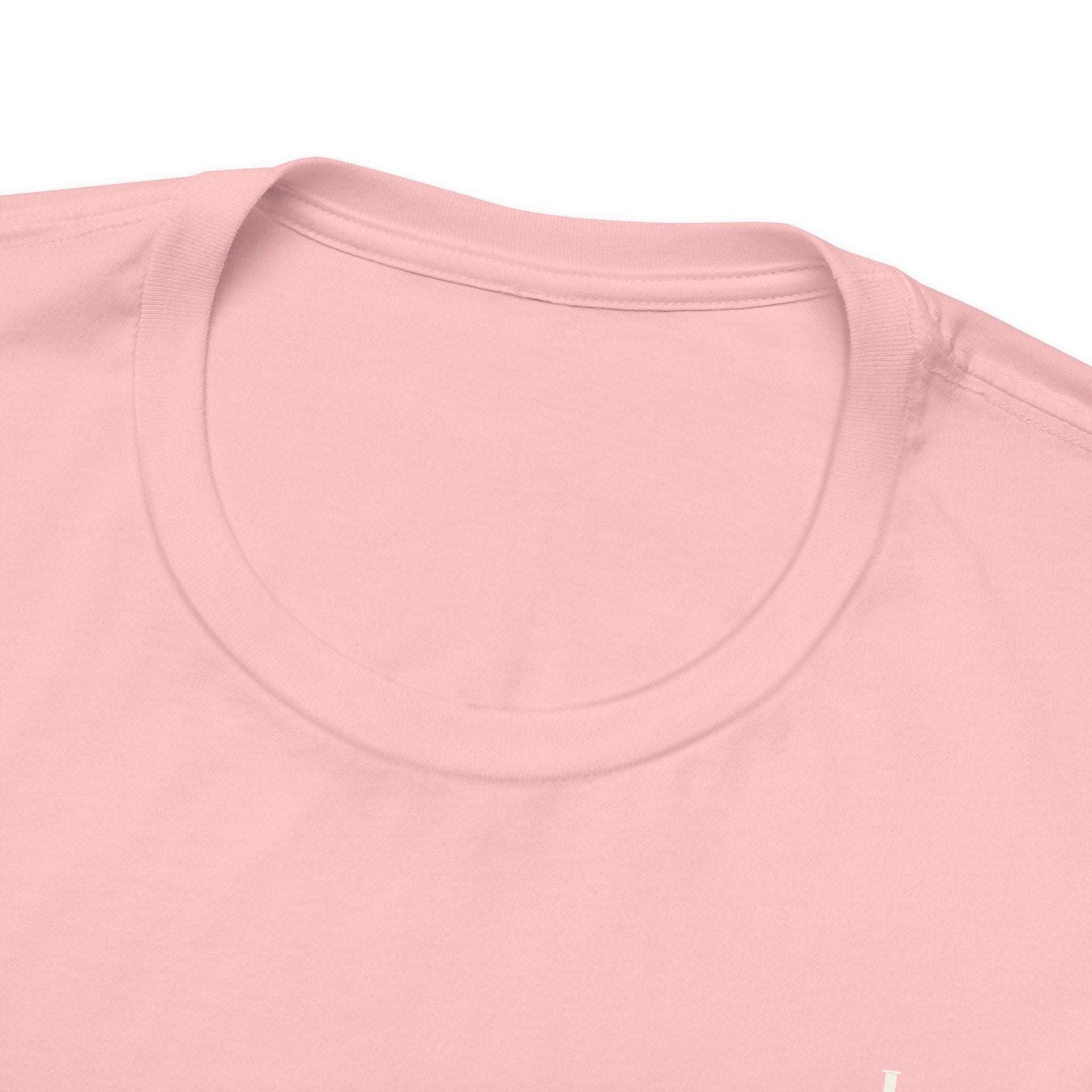 A close-up view of the collar of a pink t-shirt.