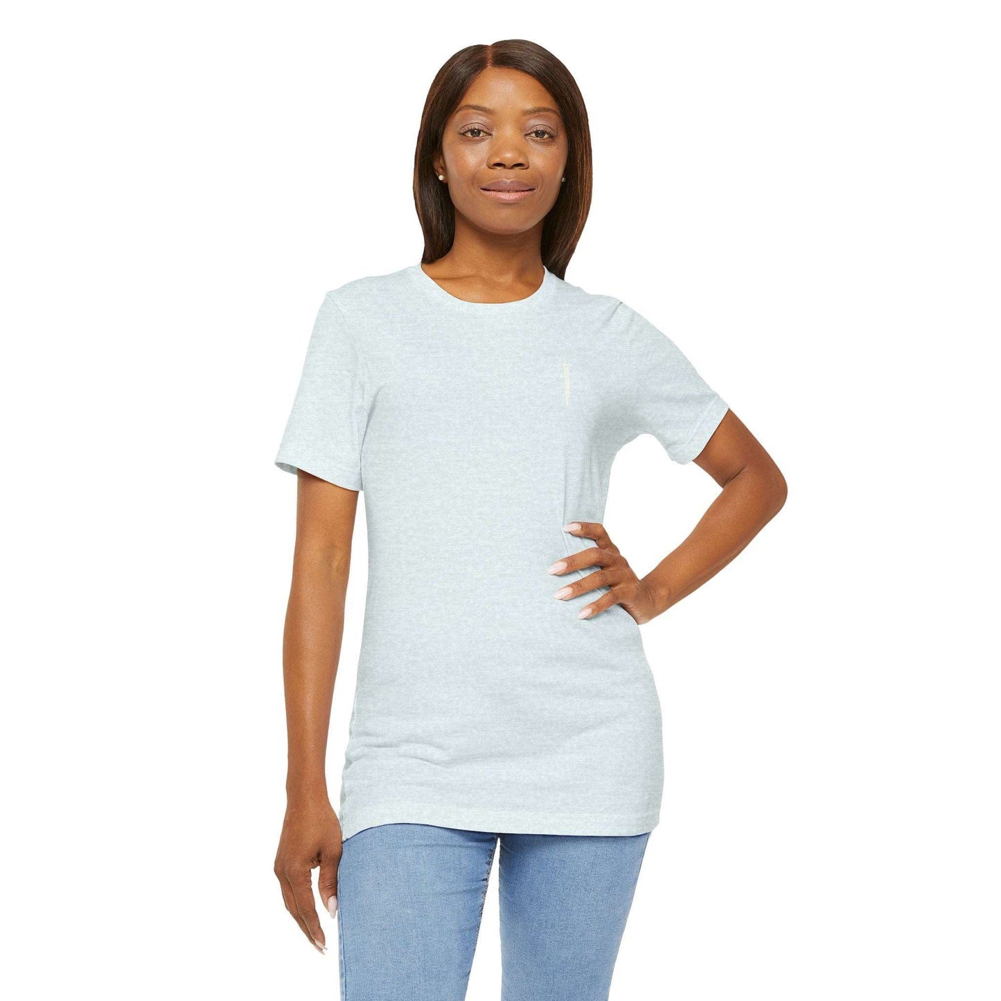 A plain light blue t-shirt on a model featuring a small white sword graphic on the upper left chest, evoking a subtle medieval aesthetic.