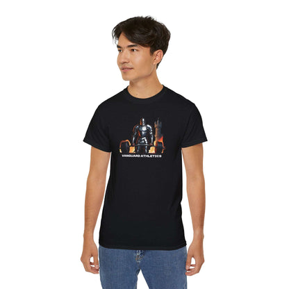 A person confidently wearing a black gym shirt with a graphic of a knight sitting on a throne, labeled Vanguard Athletics. They have short dark hair and are also rocking blue jeans, making this outfit their new addition to casual fashion.