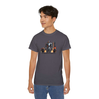 A person confidently wearing a gray gym shirt with a graphic of a knight sitting on a throne, labeled Vanguard Athletics. They have short dark hair and are also rocking blue jeans, making this outfit their new addition to casual fashion.