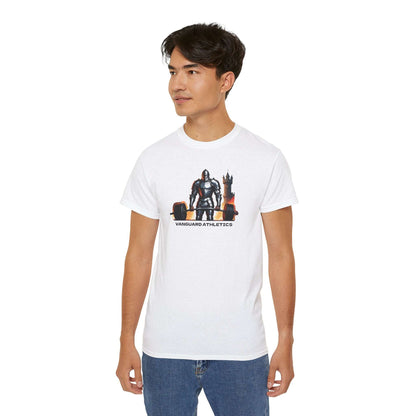 A person confidently wearing a white gym shirt with a graphic of a knight sitting on a throne, labeled Vanguard Athletics. They have short dark hair and are also rocking blue jeans, making this outfit their new addition to casual fashion.